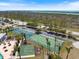 Scenic aerial view showcasing the community's tennis and basketball courts nestled amongst lush greenery and nearby waterways at 8403 Placida Rd # 304, Placida, FL 33946