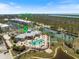 A bird's eye view showcasing the pool, tennis courts, and community center at 8403 Placida Rd # 304, Placida, FL 33946
