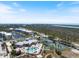 Expansive aerial shot of the community, with a swimming pool, tennis courts, pond, clubhouse and residential buildings at 8403 Placida Rd # 304, Placida, FL 33946