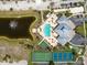 Aerial view showcasing the community's pool, tennis and basketball courts, pond, and clubhouse at 8403 Placida Rd # 304, Placida, FL 33946