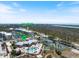 A bird's eye view showcasing the pool, tennis courts, and community center at 8403 Placida Rd # 304, Placida, FL 33946