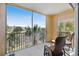 Spacious screened balcony with seating and a view of the surrounding palm trees and community at 8403 Placida Rd # 304, Placida, FL 33946