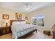 Bright bedroom featuring a queen-size bed, ceiling fan, and a large window with a view at 8403 Placida Rd # 304, Placida, FL 33946