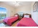 Bright bedroom featuring twin beds and a beautiful outdoor view at 8403 Placida Rd # 304, Placida, FL 33946