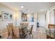 Dining room offering an open layout to the kitchen and features an elegant glass table and wicker chairs at 8403 Placida Rd # 304, Placida, FL 33946