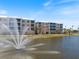 The exterior boasts a scenic view and a tranquil pond with a fountain feature at 8403 Placida Rd # 304, Placida, FL 33946