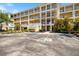 Attractive building offers convenient parking, manicured landscaping, and an inviting entrance at 8403 Placida Rd # 304, Placida, FL 33946