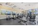 Well-equipped gym with treadmills, weight machines, and mirrors, overlooking a beautiful outdoor view and plenty of natural light at 8403 Placida Rd # 304, Placida, FL 33946