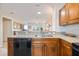 Modern kitchen with granite countertops and stainless steel dishwasher, offering an open layout to the living area at 8403 Placida Rd # 304, Placida, FL 33946