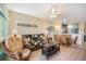 Comfortable living room with wicker furniture, ceiling fan, and an open design to the kitchen and dining area at 8403 Placida Rd # 304, Placida, FL 33946