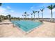 Resort-style pool with plenty of lounge seating, lush landscaping, and swaying palm trees at 8403 Placida Rd # 304, Placida, FL 33946
