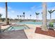 Beautiful swimming pool and spa area with lounge chairs and palm trees under a sunny, blue sky at 8403 Placida Rd # 304, Placida, FL 33946