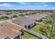 Expansive aerial perspective of a home with a spacious backyard, enclosed patio, and privacy fence at 8997 Excelsior Loop, Venice, FL 34293