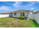Private backyard featuring a well-kept lawn and screened in patio area, perfect for outdoor enjoyment at 8997 Excelsior Loop, Venice, FL 34293