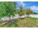 Large, well-maintained backyard with mature trees providing shade, ideal for outdoor enjoyment and privacy at 8997 Excelsior Loop, Venice, FL 34293