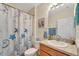 Well-maintained bathroom featuring decorative shower curtain and a vanity with ample counter space at 8997 Excelsior Loop, Venice, FL 34293