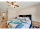 Bedroom featuring ceiling fan and coastal-themed bedding at 8997 Excelsior Loop, Venice, FL 34293