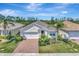 Charming single-story home with a well-manicured lawn and a brick driveway, offering a welcoming curb appeal at 8997 Excelsior Loop, Venice, FL 34293