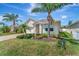 Well-maintained home with lush landscaping, a charming walkway, and vibrant curb appeal at 8997 Excelsior Loop, Venice, FL 34293