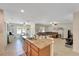 Open concept kitchen featuring a breakfast bar that overlooks the dining and living areas, perfect for entertaining at 8997 Excelsior Loop, Venice, FL 34293
