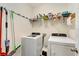Functional laundry room with front loading washer/dryer and wire shelving for storage at 8997 Excelsior Loop, Venice, FL 34293