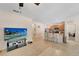 Bright, open-concept living space with tile floors, a kitchen island with seating, and seamless flow at 8997 Excelsior Loop, Venice, FL 34293