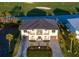 Breathtaking aerial view of a luxurious property featuring a dark roof, manicured landscaping, and a paved driveway at 9810 Eagle Preserve Dr, Englewood, FL 34224