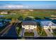 Captivating aerial view of an exquisite property nestled next to a beautiful golf course and glistening waterway at 9810 Eagle Preserve Dr, Englewood, FL 34224