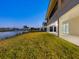 Well-maintained backyard with a lawn, a pond, and views of the golf course at 9810 Eagle Preserve Dr, Englewood, FL 34224