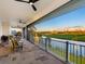 Enjoy the luxurious balcony with stunning golf course views and comfortable seating at 9810 Eagle Preserve Dr, Englewood, FL 34224