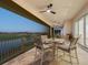 Beautiful outdoor seating area on a balcony overlooking a scenic golf course and tranquil waters at 9810 Eagle Preserve Dr, Englewood, FL 34224