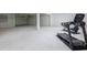 Unfinished basement with fitness equipment and a garage door at 9810 Eagle Preserve Dr, Englewood, FL 34224