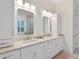 Bright bathroom featuring double vanity, ample storage, and neutral color palette at 9810 Eagle Preserve Dr, Englewood, FL 34224