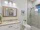 Well-lit bathroom featuring a vanity, shower, and toilet at 9810 Eagle Preserve Dr, Englewood, FL 34224