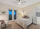 Bright bedroom featuring carpeted floors, balcony access, and neutral decor at 9810 Eagle Preserve Dr, Englewood, FL 34224