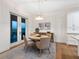 Elegant dining area with access to outdoor view, complemented by stylish furnishings and decor at 9810 Eagle Preserve Dr, Englewood, FL 34224