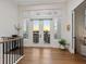 Bright entryway with wood floors and balcony access provides stunning water views at 9810 Eagle Preserve Dr, Englewood, FL 34224