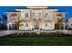 Stunning two-story home showcasing manicured landscaping, a brick driveway, and a charming front entrance at 9810 Eagle Preserve Dr, Englewood, FL 34224