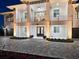 Elegant two-story home showcasing impeccable landscaping, a stone driveway, and a welcoming entrance at 9810 Eagle Preserve Dr, Englewood, FL 34224