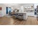 Modern kitchen with center island, stainless steel appliances, and adjacent dining area for easy entertaining at 9810 Eagle Preserve Dr, Englewood, FL 34224