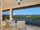 Outdoor lanai featuring comfortable seating and beautiful views of the pond and golf course at 9810 Eagle Preserve Dr, Englewood, FL 34224