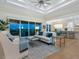 Sun-filled living room opens to a modern kitchen and has access to a spacious balcony at 9810 Eagle Preserve Dr, Englewood, FL 34224