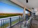 Comfortable seating on the patio overlooks water and golf course views at 9810 Eagle Preserve Dr, Englewood, FL 34224