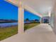 Covered patio with views of the lush lawn, pond, and golf course at 9810 Eagle Preserve Dr, Englewood, FL 34224