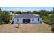 View of back of home with a screened in lanai surrounded by a large yard and minimal landscaping at 10153 Gasparilla Rd, Placida, FL 33946