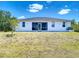 Expansive backyard featuring a screened in porch and an expansive grassy area at 10153 Gasparilla Rd, Placida, FL 33946