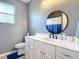 Bathroom with a vanity, modern black fixtures, and a round mirror at 10153 Gasparilla Rd, Placida, FL 33946