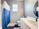 Bathroom with a blue and white shower curtain, vanity with sink, and a mirror at 10153 Gasparilla Rd, Placida, FL 33946