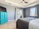 Well-lit bedroom featuring a tray ceiling, tile floors, and sliding doors to a screened lanai at 10153 Gasparilla Rd, Placida, FL 33946