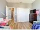 Bedroom with hardwood floors, a closet, and pink desk at 10153 Gasparilla Rd, Placida, FL 33946